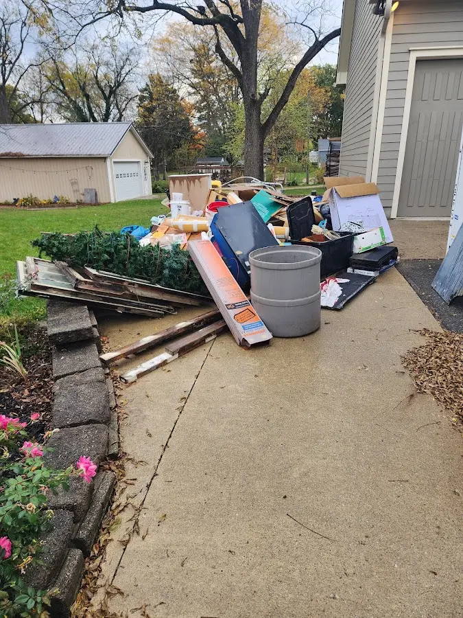 Dumpster being loaded with debris for Estate Cleanout Dumpster Rental in East Greenbush